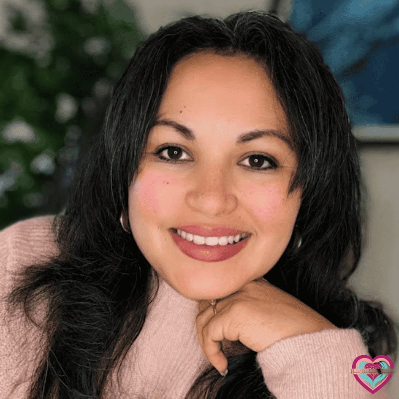 Close-up portrait of Marcie Rey Landreth, LCSW, smiling in a soft pink sweater, conveying warmth, confidence, and compassion.
