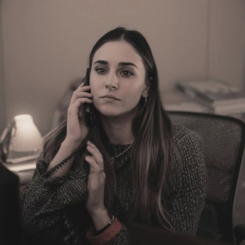 person on a phone call with a calm and focused expression receiving guidance and support